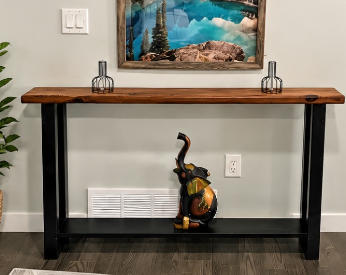 Custom console table with a rustic solid wood top, black metal legs and a lower shelf, built by Handyman Reid in Edmonton