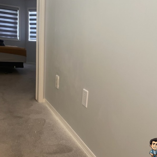 Smooth repaired and painted wall beside a bedroom door after drywall repair